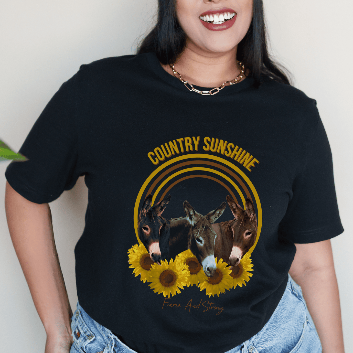 charming t-shirt featuring three adorable donkeys surrounded by vibrant sunflowers! This delightful design captures the essence of country sunshine, making it the perfect addition to your casual wardrobe.