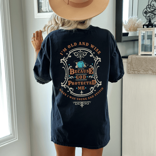 Funny t-shirt that perfectly captures the wisdom that comes with age and the protection of God! This witty shirt features the humorous phrase old and wise because God protected me when I was young and stupid.