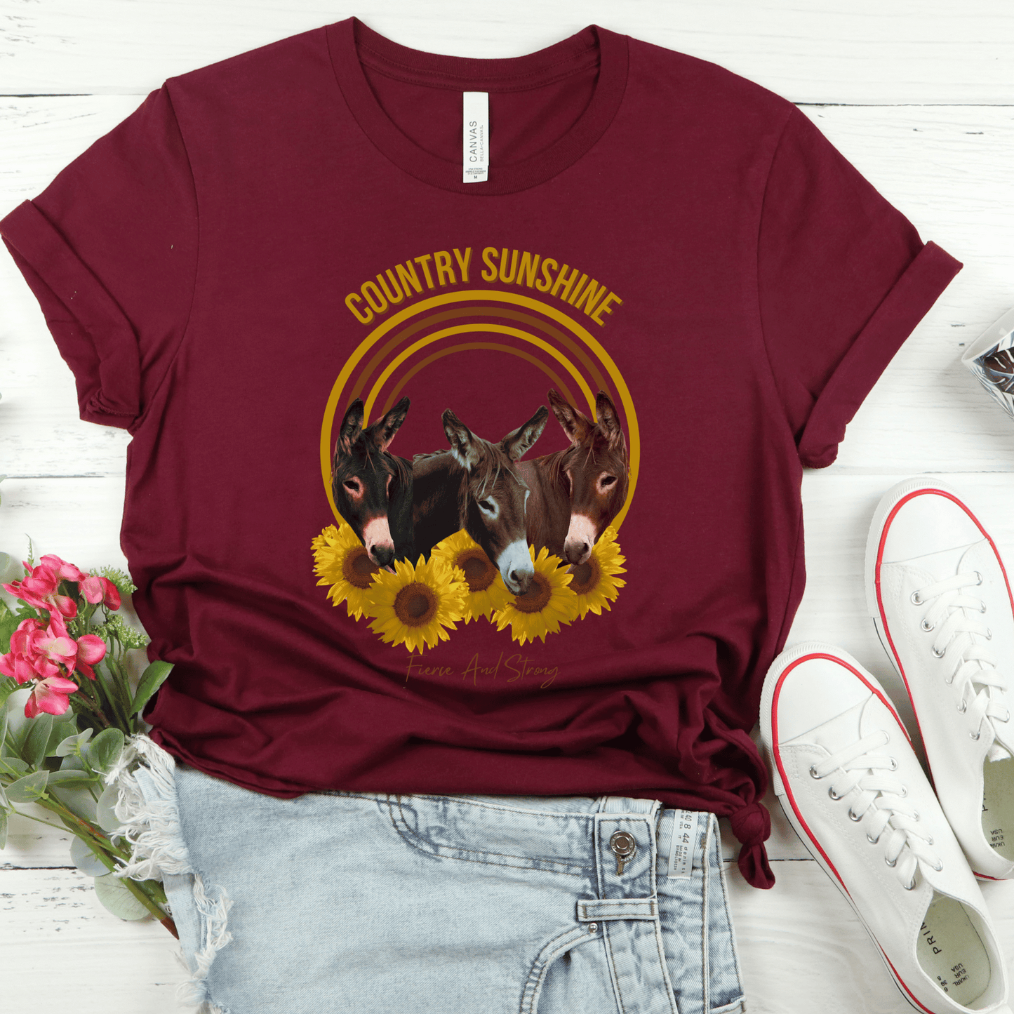 charming t-shirt featuring three adorable donkeys surrounded by vibrant sunflowers! This delightful design captures the essence of country sunshine, making it the perfect addition to your casual wardrobe.