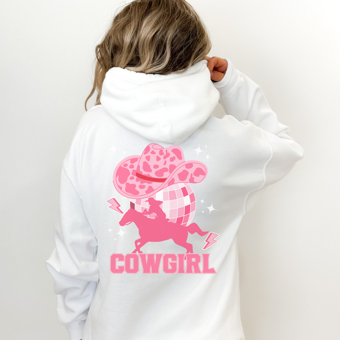 Disco Cowgirl, meets space cowgirl design on the back In a large design and a small print on the left chest area printed on a pullover hoodie.