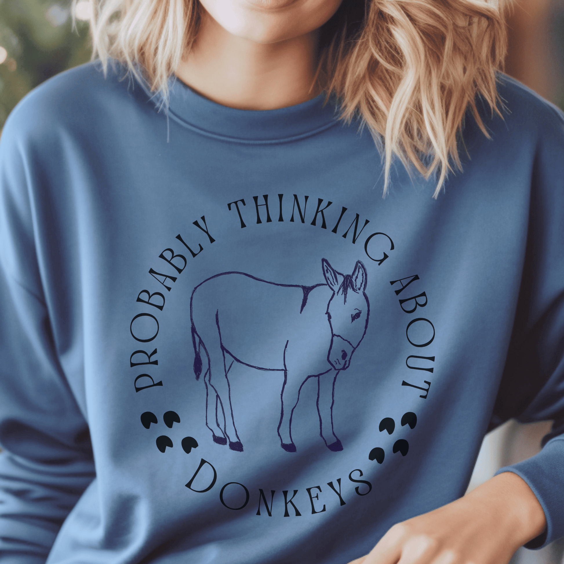 Probalby thinking about Donkeys with a cute outline of a donkey on a crewneck sweatshirt.