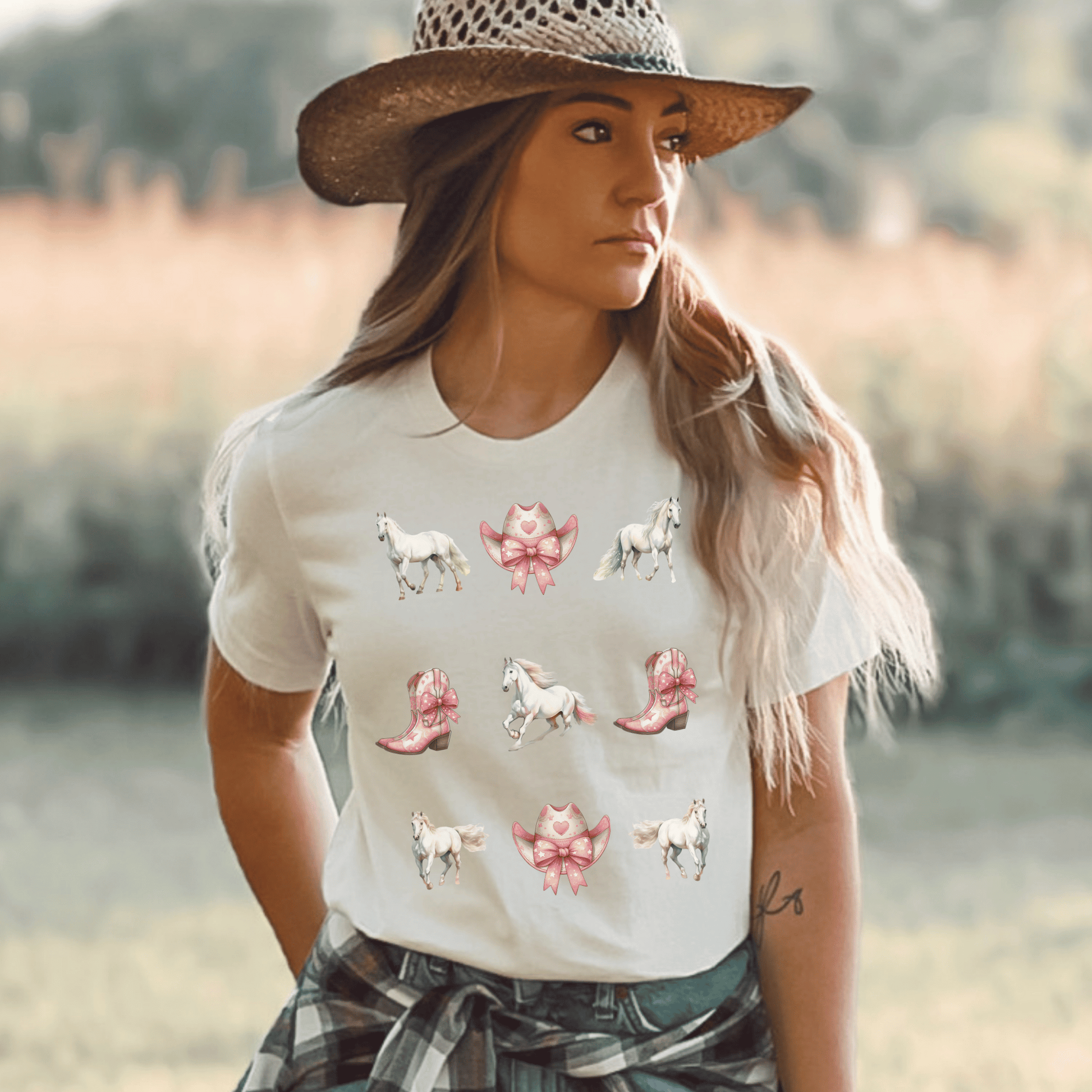 A Coquette cowgirl design with white horses and pink cowboy boots and cowboy hats on a cute t-shirt.