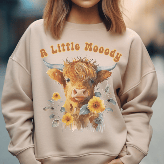  sweatshirt featuring a little moody saying, perfectly complemented by an adorable Highland cow calf and a radiant arrangement of sunflowers. 