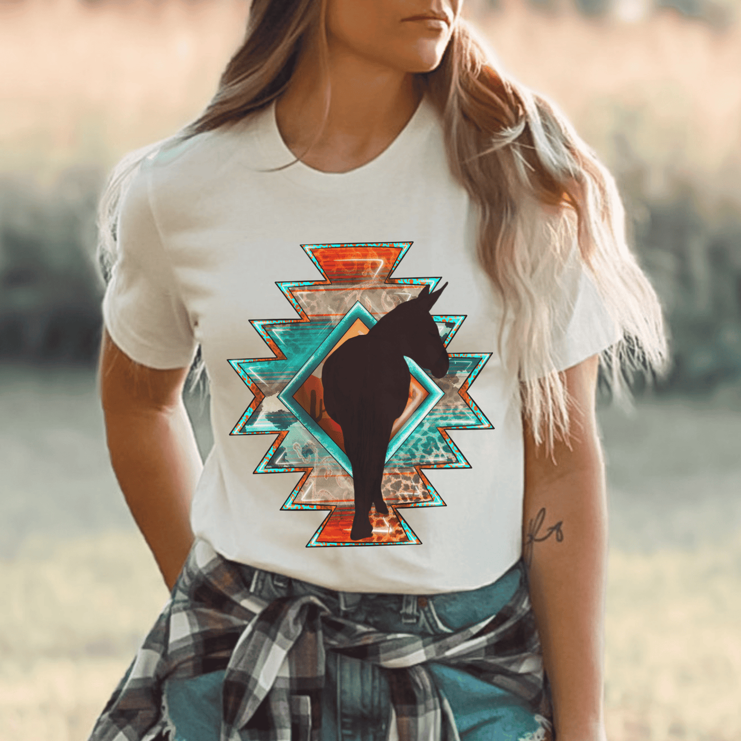  Southwestern-style graphic tee featuring a charming donkey silhouette! This shirt is perfect for animal lovers and those who embrace a farm, ranch, or country lifestyle. If you're a donkey enthusiast, this shirt is a must-have! Show off your love for these adorable animals or surprise a fellow donkey lover with a thoughtful gift from our donkey collection.