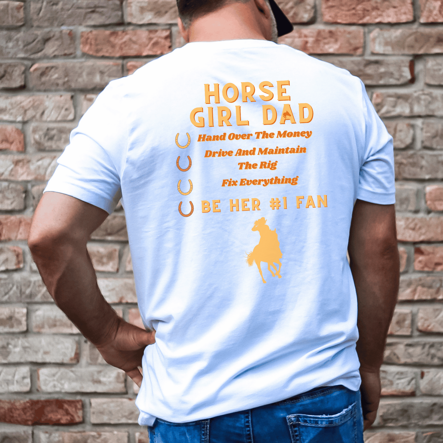 This t-shirt features the word "Dad" on the front and "Horse Girl Dad" on the back, along with the phrase "Hand Over the Money, Drive and Maintain the Rig, Fix Everything, and Be Her #1 Fan." It's a fun and playful way to show your love and support for your daughter's passion for horses.