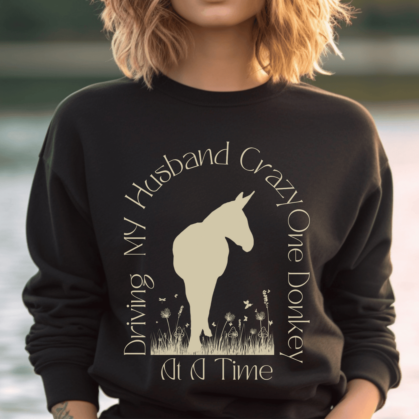 Driving My Husband Crazy One Donkey at a Time Crew Neck Sweatshirt! Show off your playful side with this fun and whimsical design that is bound to turn heads. Crafted with a premium quality blend of fabrics, this sweatshirt ensures maximum comfort and durability.