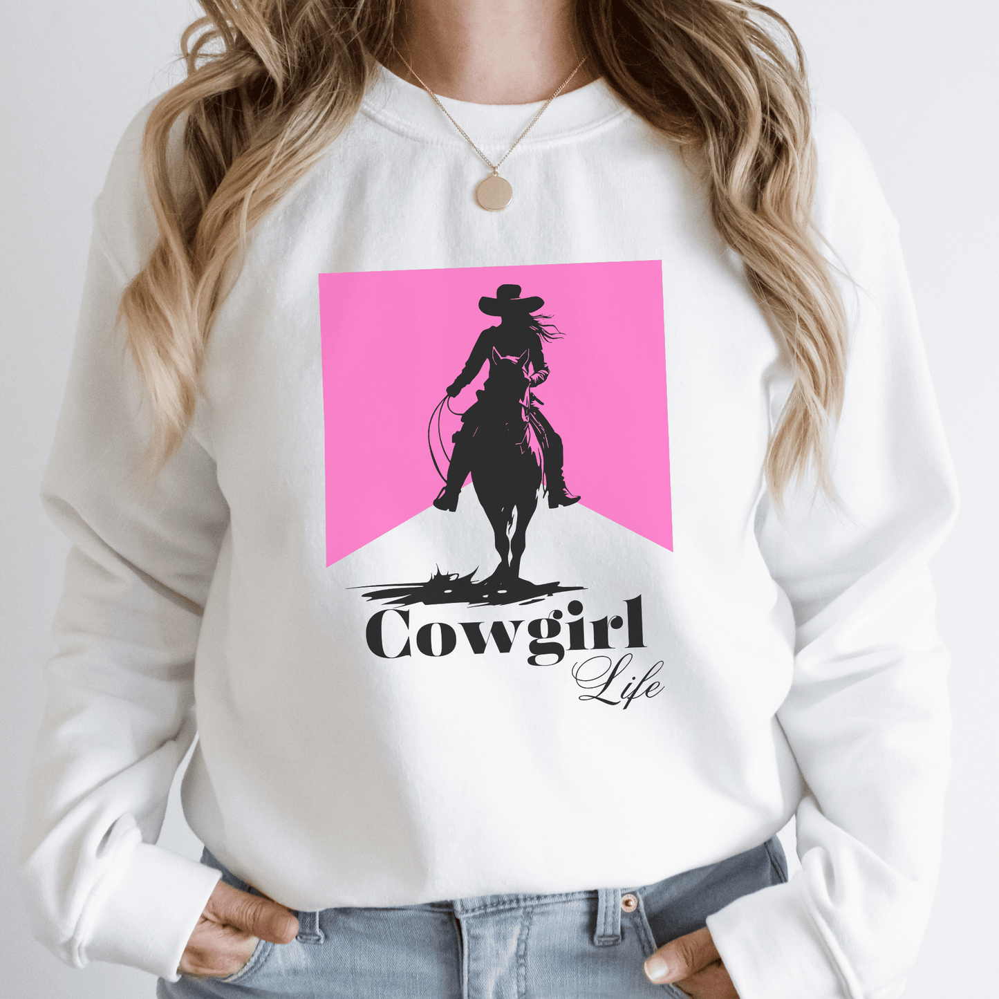 Cowgirl design that says cowgirl Life With a pink background on a crew neck sweatshirt.