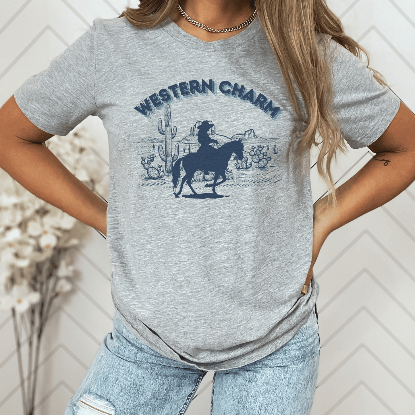 This crew neck t-shirt features a stunning western style print proudly showcasing the words western charm. Crafted from quality materials, this t-shirt is not only trendy but also super soft and breathable, ensuring you stay comfortable all day long.