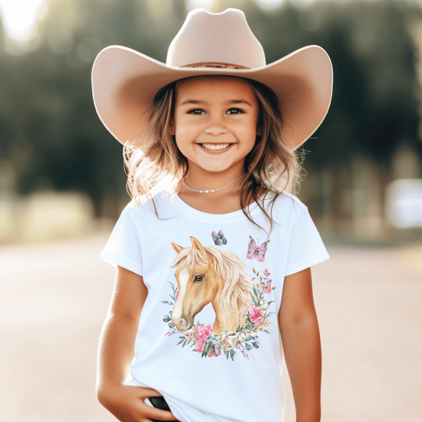  charming Youth T-Shirt adorned with a breathtaking Palomino horse, delicate floral motifs, and enchanting butterfly design.&nbsp; This fashion-forward tee will make your little one feel as graceful as a butterfly and as elegant as a Palomino horse. 