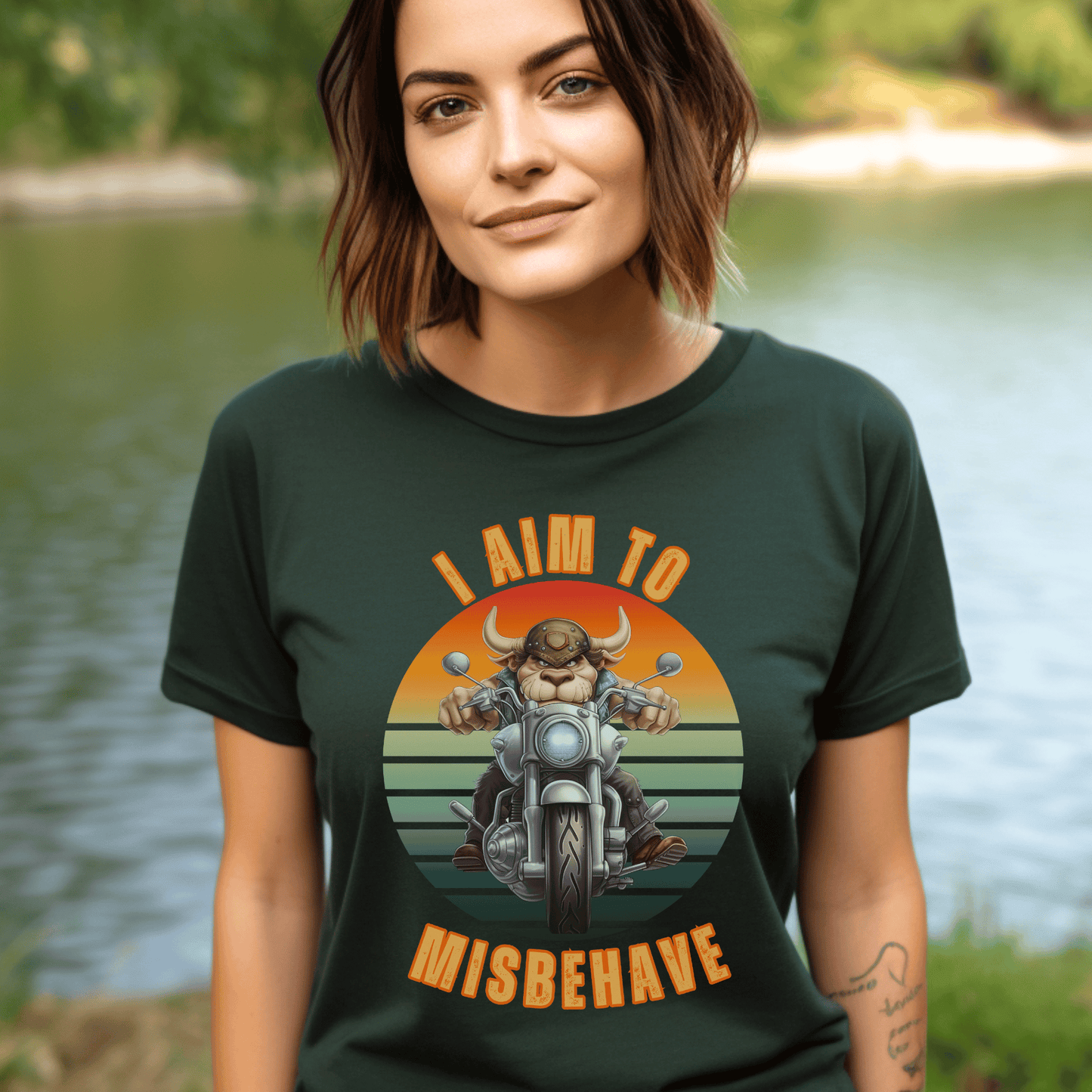 Funny tee with a bull that is riding a motorcycle with a vintage scene and text that says I aim to misbehave ptinted on a round neck t-shirt.