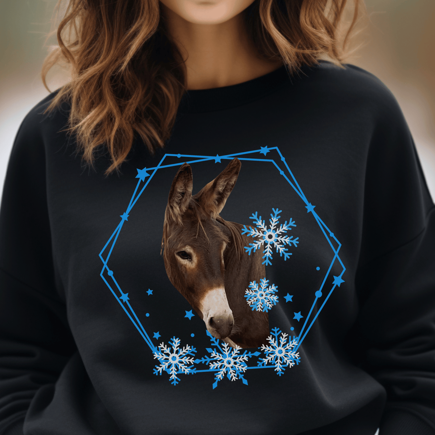 Brown Donkey surrounded by blue and white snowflakes on a crew neck sweatshirt.