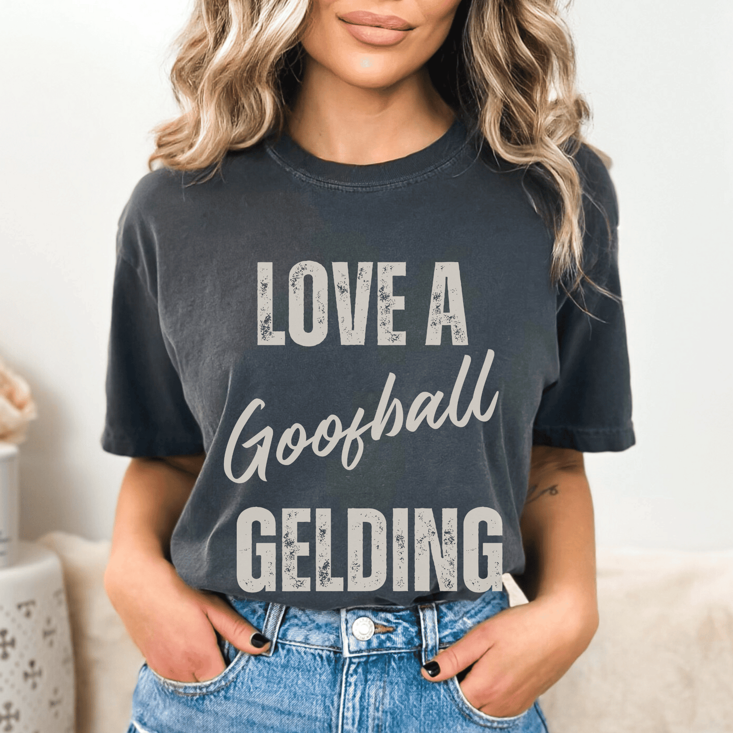 Graphic tee with the saying love a goofball gelding printed on a comfort colors tee.