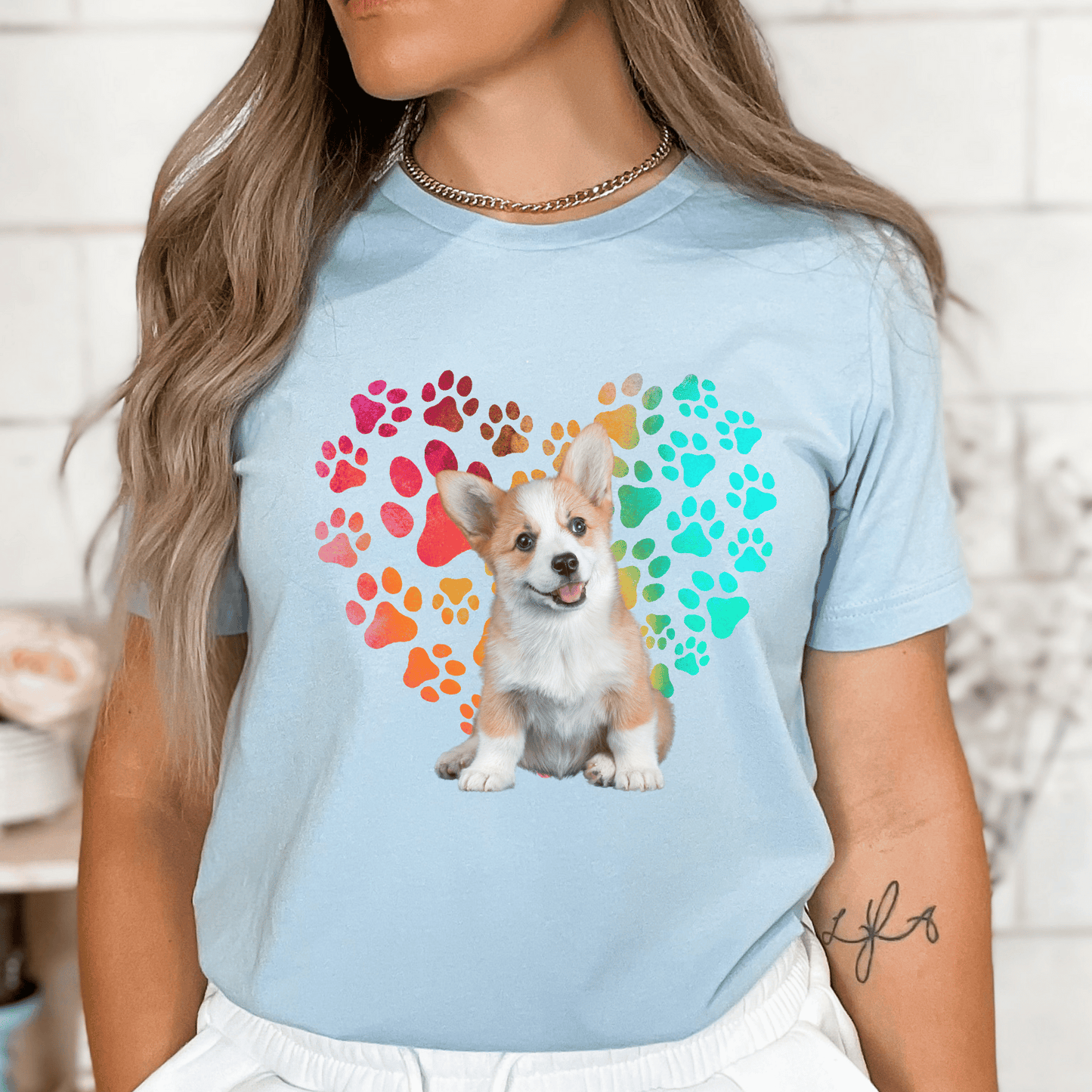 This Corgi Dog t-shirt features a paw print heart in the background, making it a unique and thoughtful gift for dog lovers, pet owners, and Corgi moms. The shirt is perfect for anyone who wants to show off their love for their furry friend.