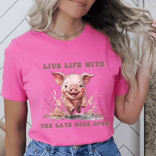 Introducing our Cute Piggy Tee, featuring a charming little pig happily running through the mud. With the inspirational message "Live life with the gate wide open," this farm animal-inspired t-shirt is perfect for anyone who loves country life. Made from high-quality materials, this pink pig shirt is both comfortable and stylish. Order now and show your love for adorable farm animals with our Piggy Shirt!