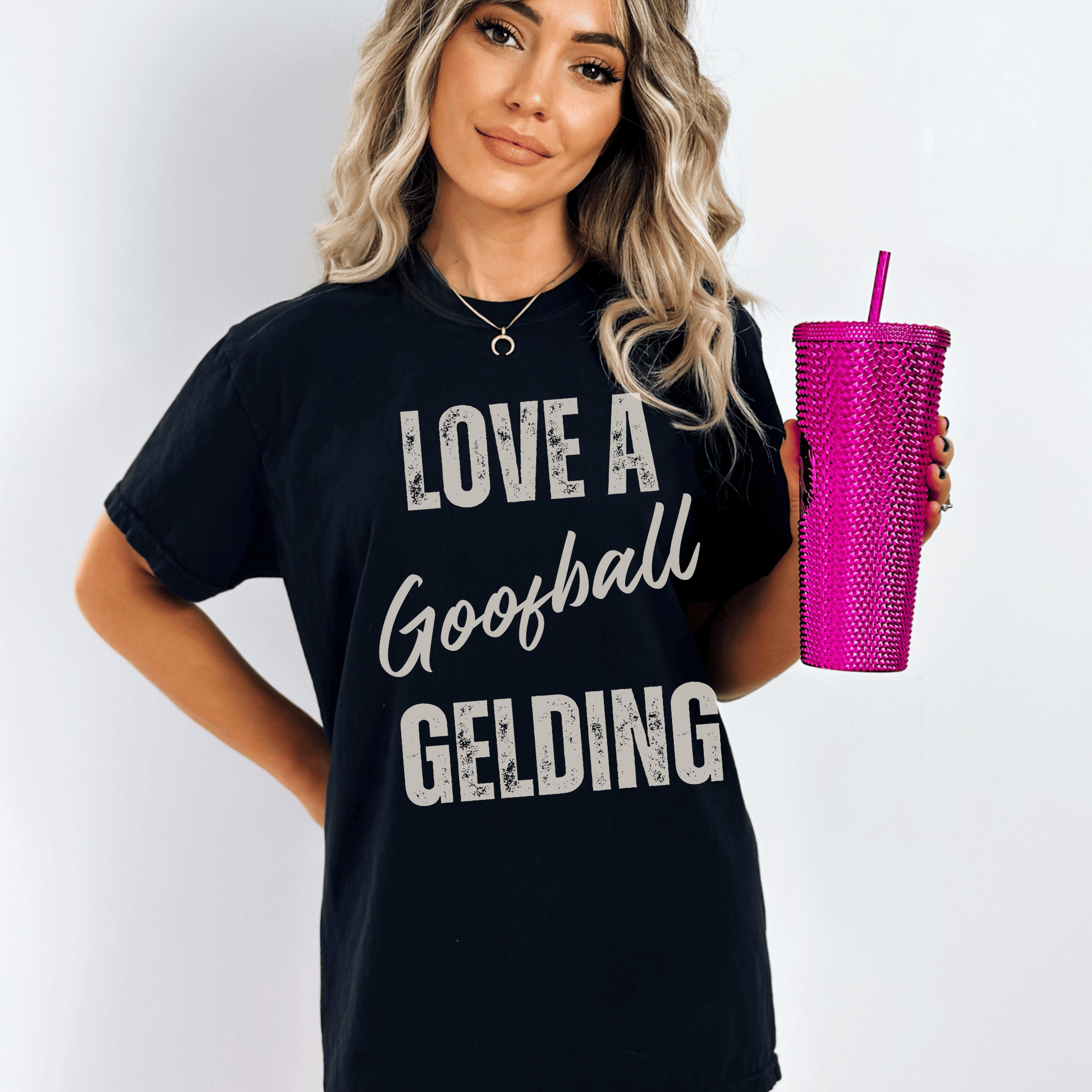 Graphic tee with the saying love a goofball gelding printed on a comfort colors tee.