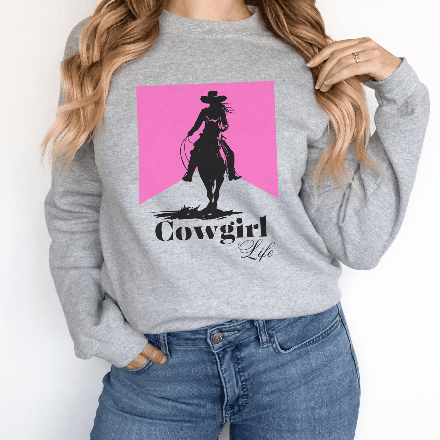 Cowgirl design that says cowgirl Life With a pink background on a crew neck sweatshirt.