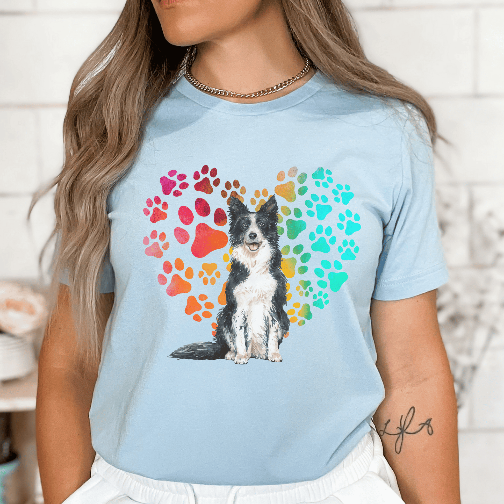 This Border Collie Dog t-shirt features a paw print heart in the background, making it a unique and thoughtful gift for dog lovers, pet owners, and Border Collie moms. The shirt is perfect for anyone who wants to show off their love for their furry friend.