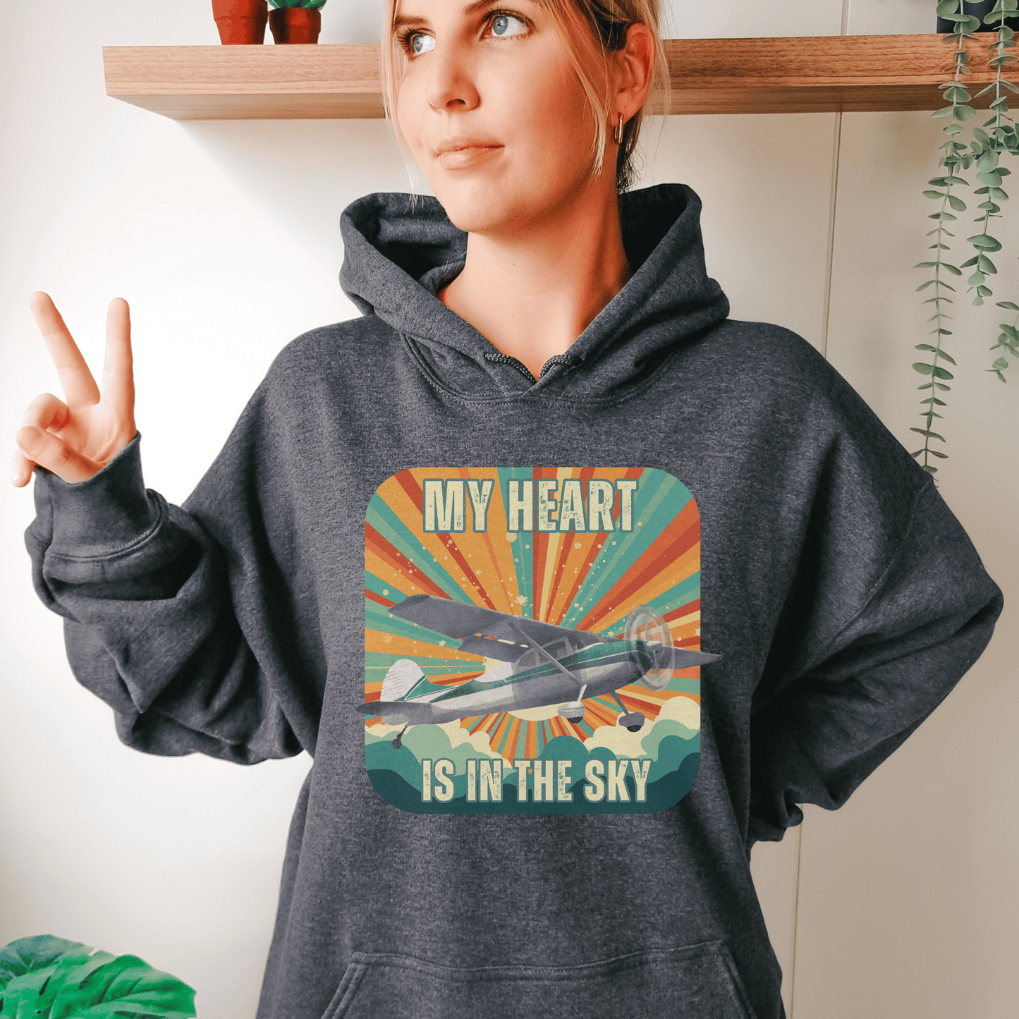 Retro Vintage Sunshine Airplane Hoodie! Stay stylish and warm with this unique design that will transport you to cloud nine. Featuring a stunning airplane design adorned with the heartfelt inscription my heart is in the sky, this hoodie is a must-have for aviation enthusiasts and lovers of all things retro