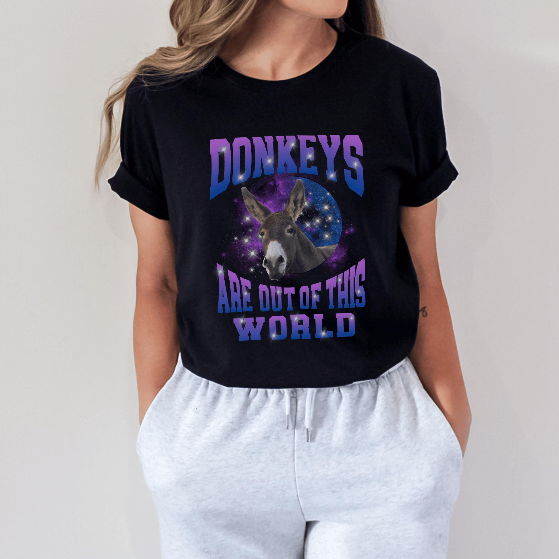 Galaxy print design with a cute donkey and the saying Donkeys are out of this world on a crewneck t-shirt.