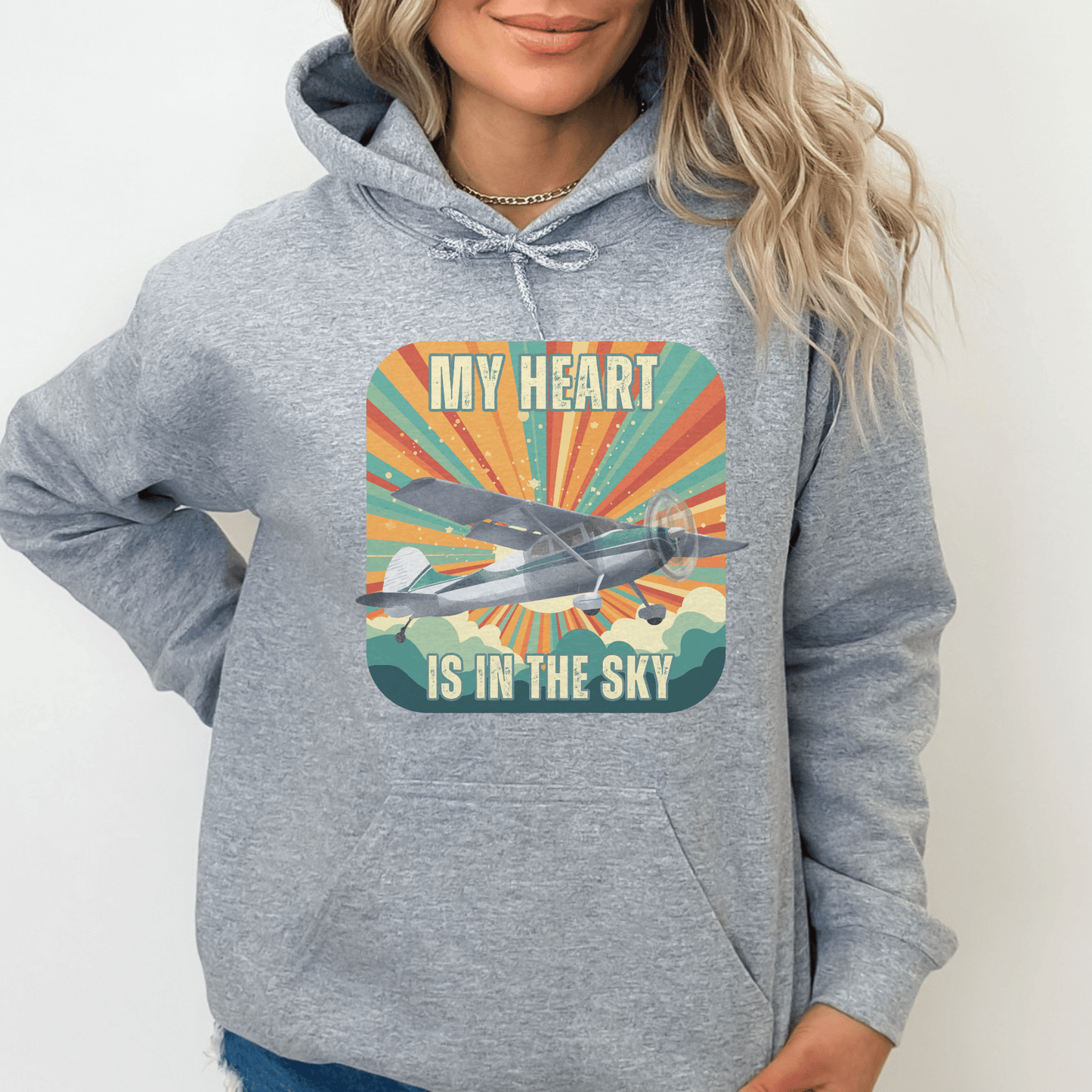 Retro Vintage Sunshine Airplane Hoodie! Stay stylish and warm with this unique design that will transport you to cloud nine. Featuring a stunning airplane design adorned with the heartfelt inscription my heart is in the sky, this hoodie is a must-have for aviation enthusiasts and lovers of all things retro