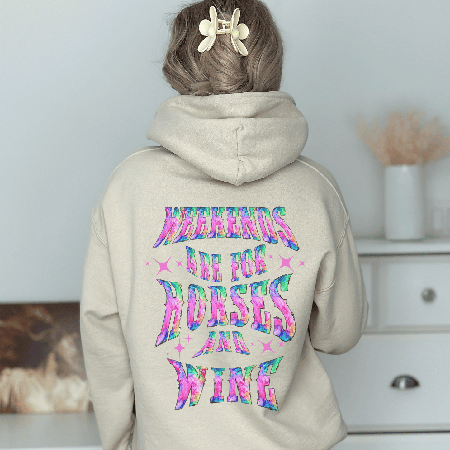 Add a touch of fun to your wardrobe with our horse girl hoodie! With a playful design on the back and tie-dye lettering, this shirt is perfect for casual outings or days spent at the barn. The "Weekends Are for Horses and Wine" message is sure to put a smile on everyone's face, and the comfortable fit ensures that you'll want to wear it all day long. If you are looking for the oversized baggy fit please size up. They run true to size.