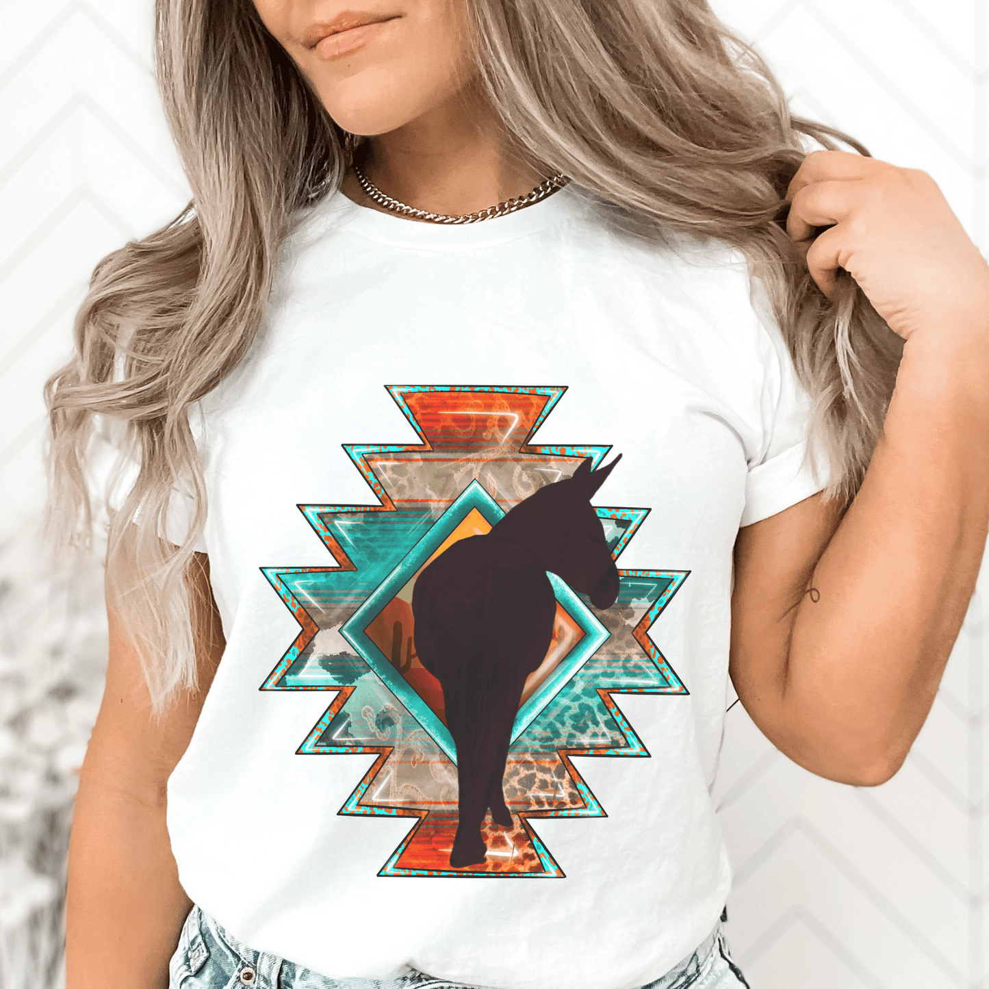  Southwestern-style graphic tee featuring a charming donkey silhouette! This shirt is perfect for animal lovers and those who embrace a farm, ranch, or country lifestyle. If you're a donkey enthusiast, this shirt is a must-have! Show off your love for these adorable animals or surprise a fellow donkey lover with a thoughtful gift from our donkey collection.