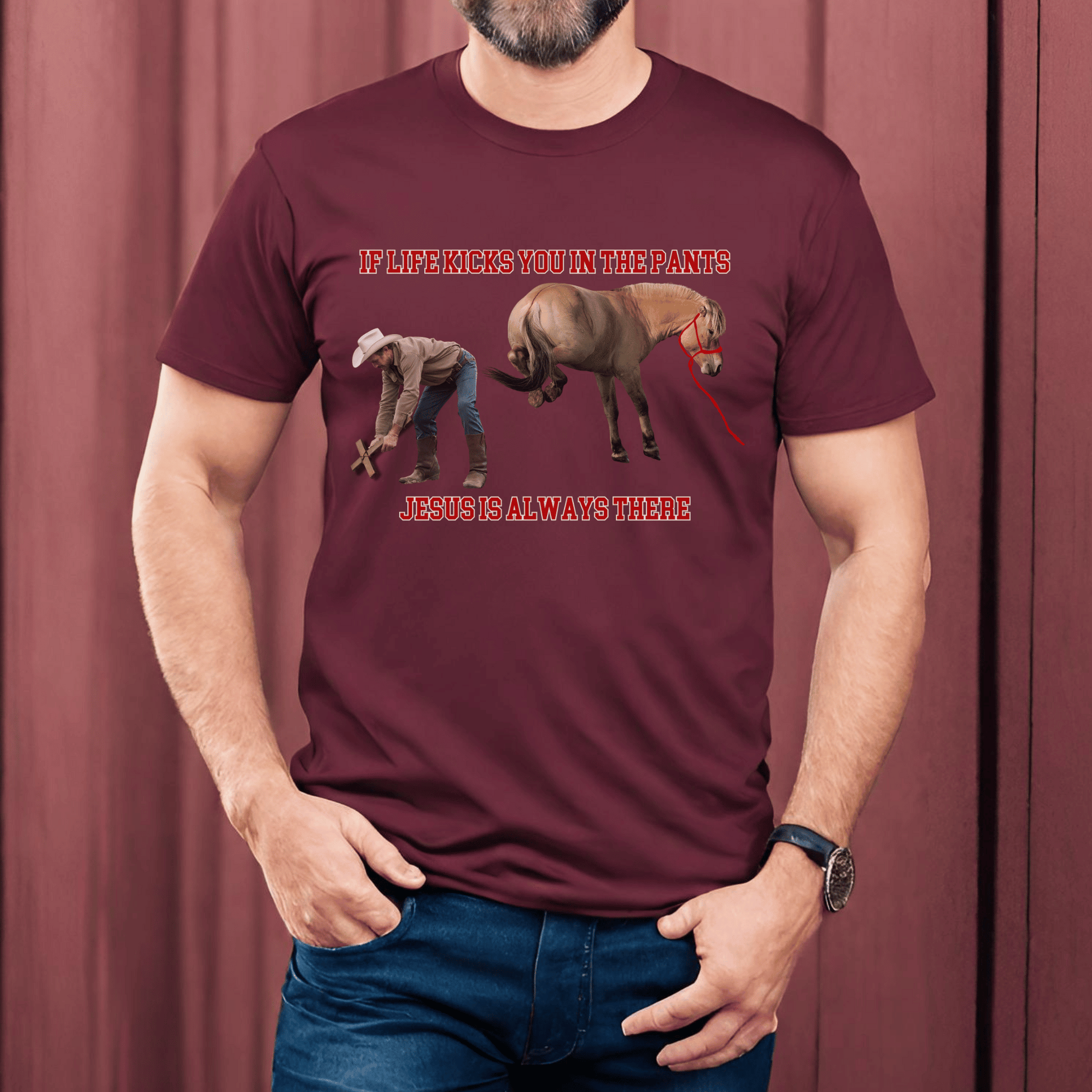 Crew Neck western t-shirt, If Life kicks you in the pants Jesus is always there. with the picture of a cowboy bending over holding a cross getting kicked by a horse.