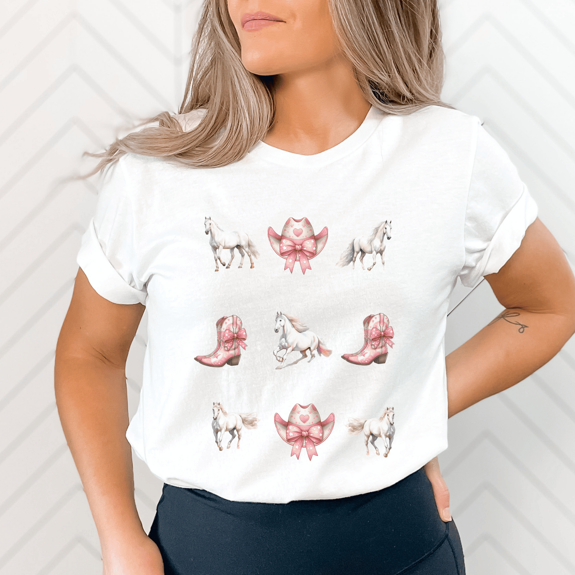 A Coquette cowgirl design with white horses and pink cowboy boots and cowboy hats on a cute t-shirt.