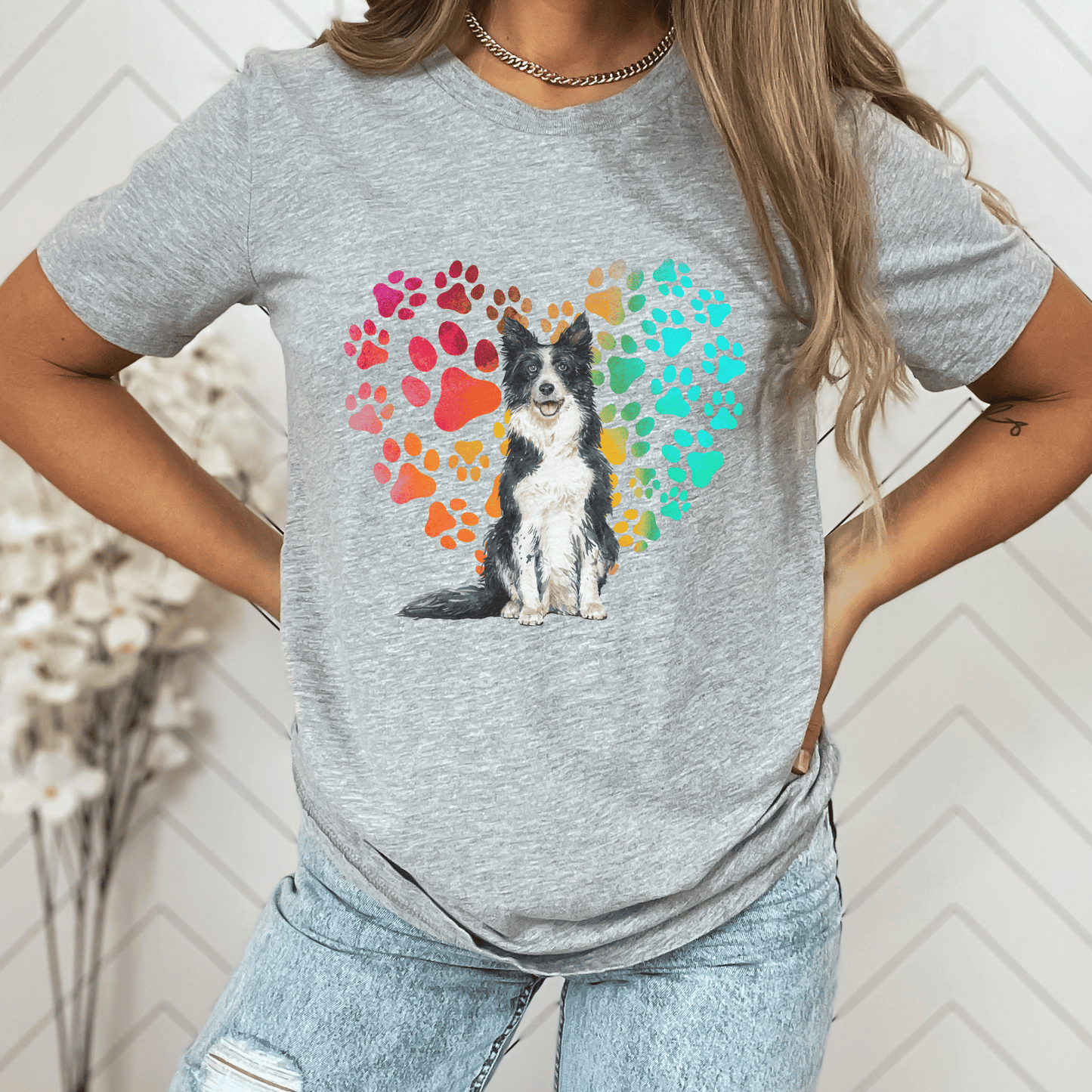 This Border Collie Dog t-shirt features a paw print heart in the background, making it a unique and thoughtful gift for dog lovers, pet owners, and Border Collie moms. The shirt is perfect for anyone who wants to show off their love for their furry friend.