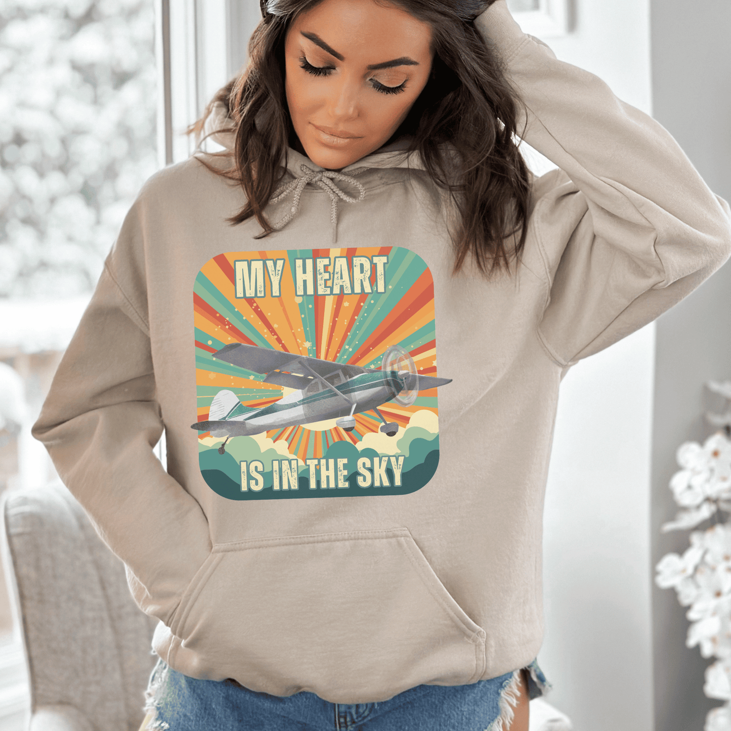 Retro Vintage Sunshine Airplane Hoodie! Stay stylish and warm with this unique design that will transport you to cloud nine. Featuring a stunning airplane design adorned with the heartfelt inscription my heart is in the sky, this hoodie is a must-have for aviation enthusiasts and lovers of all things retro