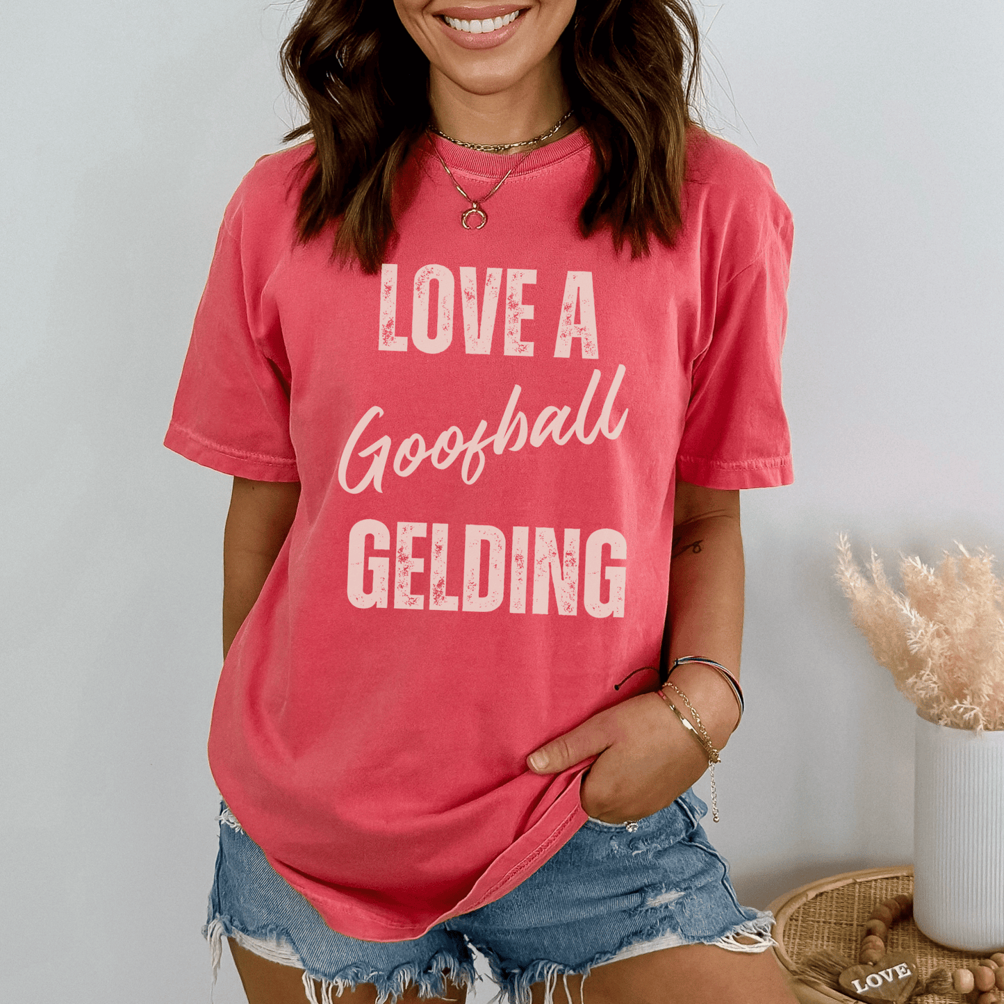 Graphic tee with the saying love a goofball gelding printed on a comfort colors tee.