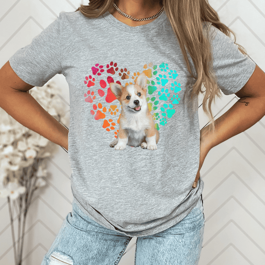 This Corgi Dog t-shirt features a paw print heart in the background, making it a unique and thoughtful gift for dog lovers, pet owners, and Corgi moms. The shirt is perfect for anyone who wants to show off their love for their furry friend.