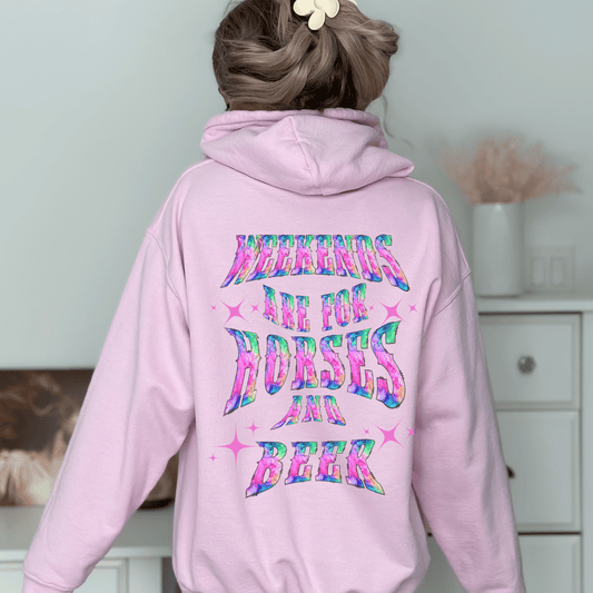 Add a touch of fun to your wardrobe with our horse girl hoodie! With a playful design on the back and tie-dye lettering, this shirt is perfect for casual outings or days spent at the barn. The "Weekends Are for Horses and Beer" message is sure to put a smile on everyone's face, and the comfortable fit ensures that you'll want to wear it all day long.