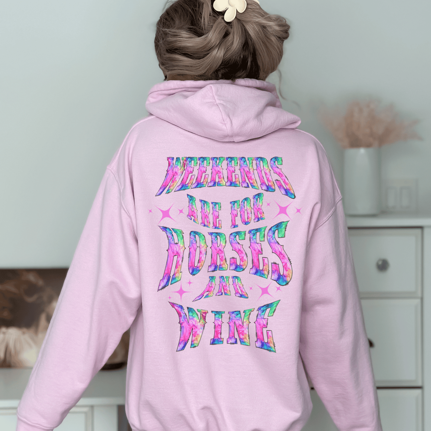 Add a touch of fun to your wardrobe with our horse girl hoodie! With a playful design on the back and tie-dye lettering, this shirt is perfect for casual outings or days spent at the barn. The "Weekends Are for Horses and Wine" message is sure to put a smile on everyone's face, and the comfortable fit ensures that you'll want to wear it all day long. If you are looking for the oversized baggy fit please size up. They run true to size.