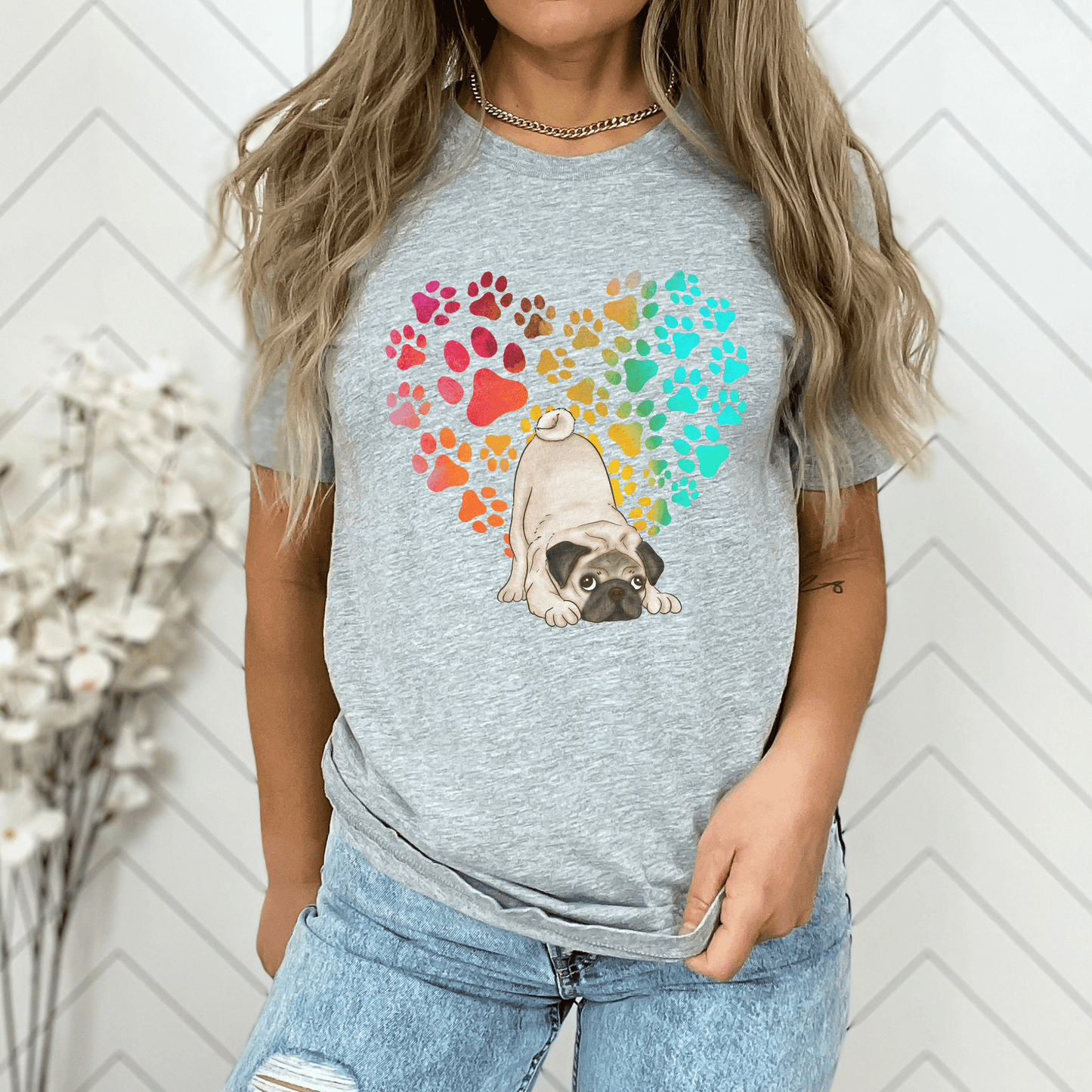 This Pug Dog t-shirt features a paw print heart in the background, making it a unique and thoughtful gift for dog lovers, pet owners, and Pug moms. The shirt is perfect for anyone who wants to show off their love for their furry friend.