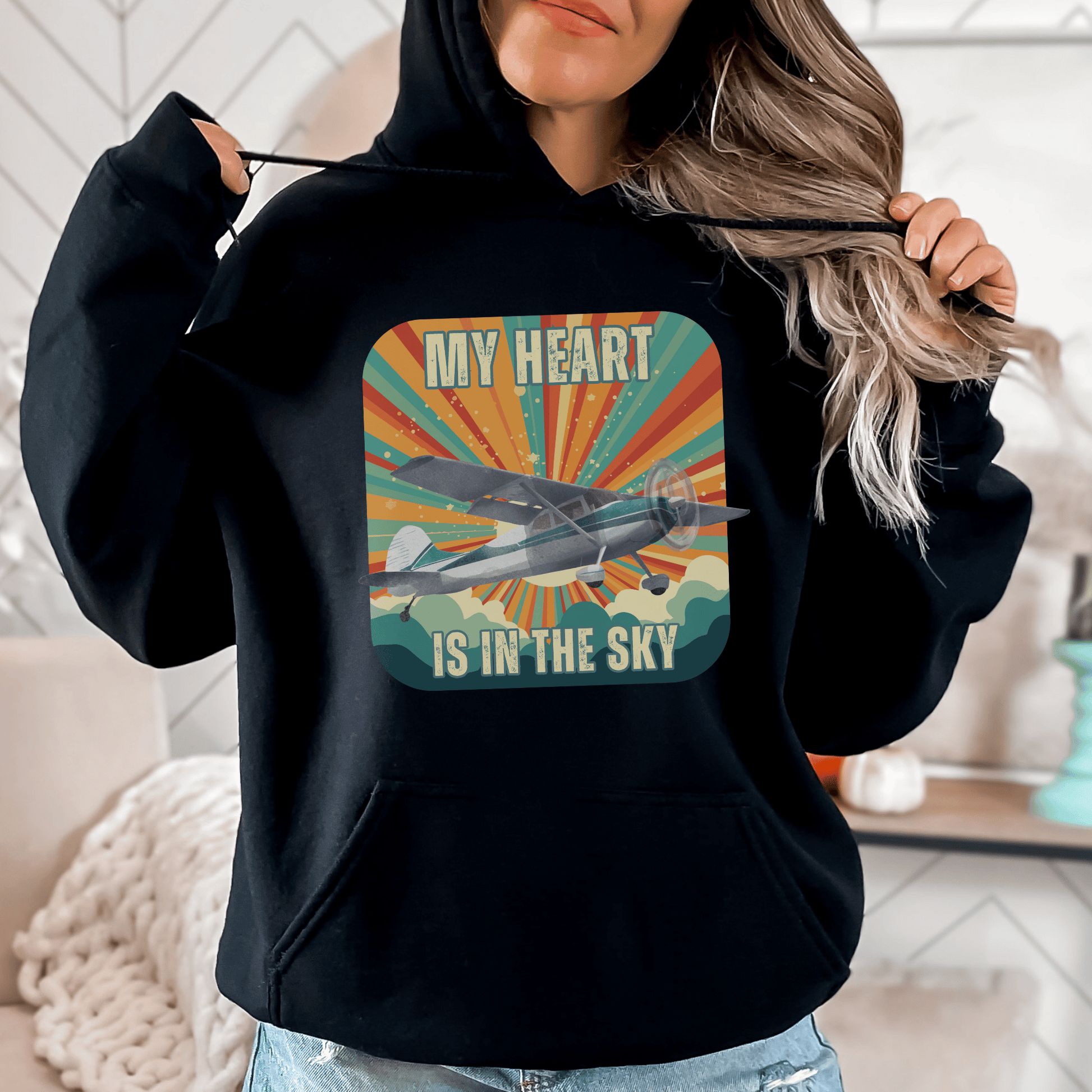 Retro Vintage Sunshine Airplane Hoodie! Stay stylish and warm with this unique design that will transport you to cloud nine. Featuring a stunning airplane design adorned with the heartfelt inscription my heart is in the sky, this hoodie is a must-have for aviation enthusiasts and lovers of all things retro