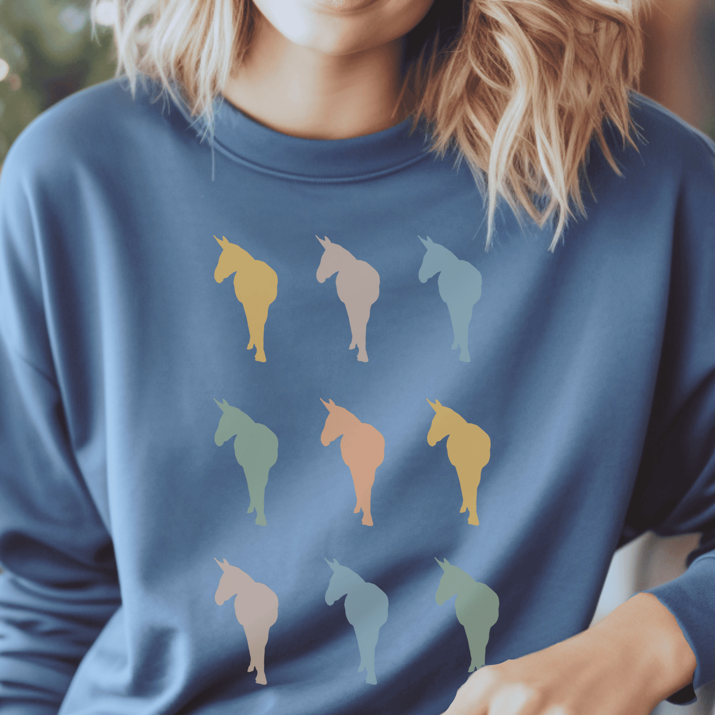 Silhouettes of Donkeys in several vintage colors on a crew neck sweatshirt.