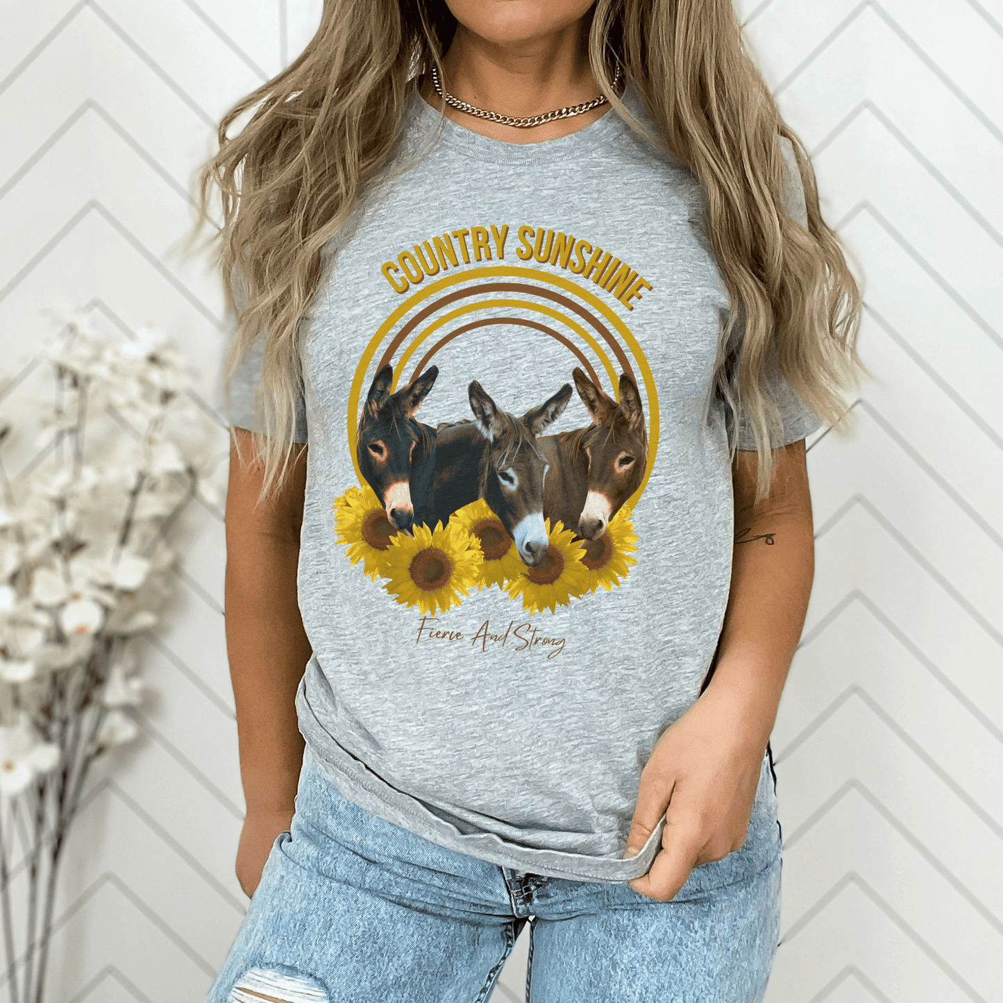 charming t-shirt featuring three adorable donkeys surrounded by vibrant sunflowers! This delightful design captures the essence of country sunshine, making it the perfect addition to your casual wardrobe.