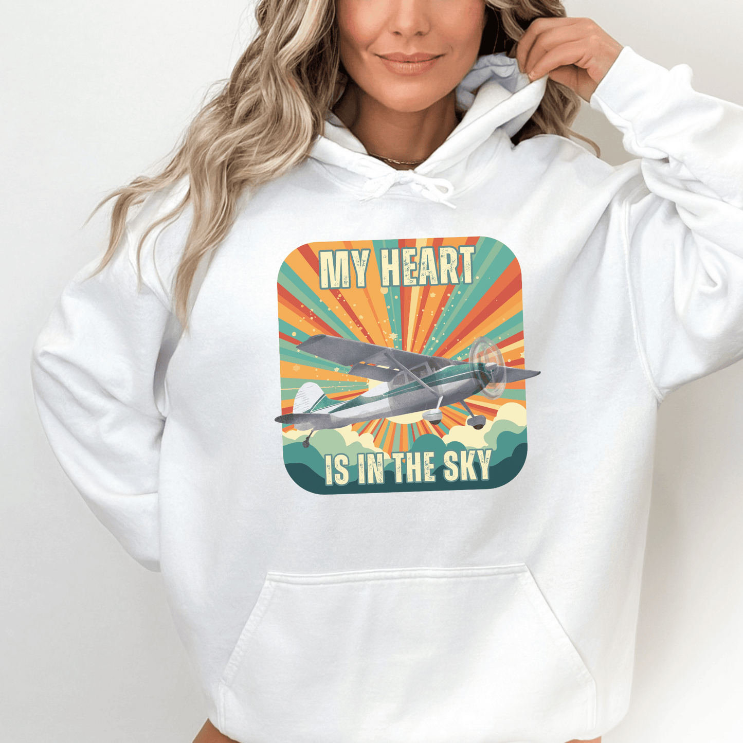 Retro Vintage Sunshine Airplane Hoodie! Stay stylish and warm with this unique design that will transport you to cloud nine. Featuring a stunning airplane design adorned with the heartfelt inscription my heart is in the sky, this hoodie is a must-have for aviation enthusiasts and lovers of all things retro