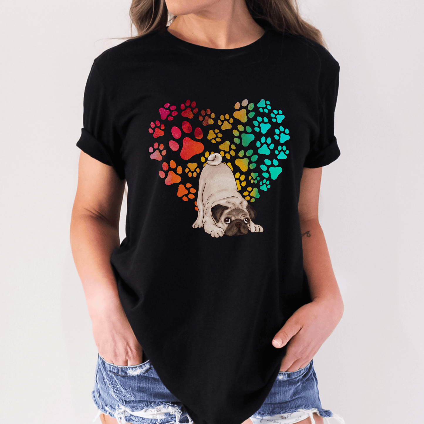 This Pug Dog t-shirt features a paw print heart in the background, making it a unique and thoughtful gift for dog lovers, pet owners, and Pug moms. The shirt is perfect for anyone who wants to show off their love for their furry friend.