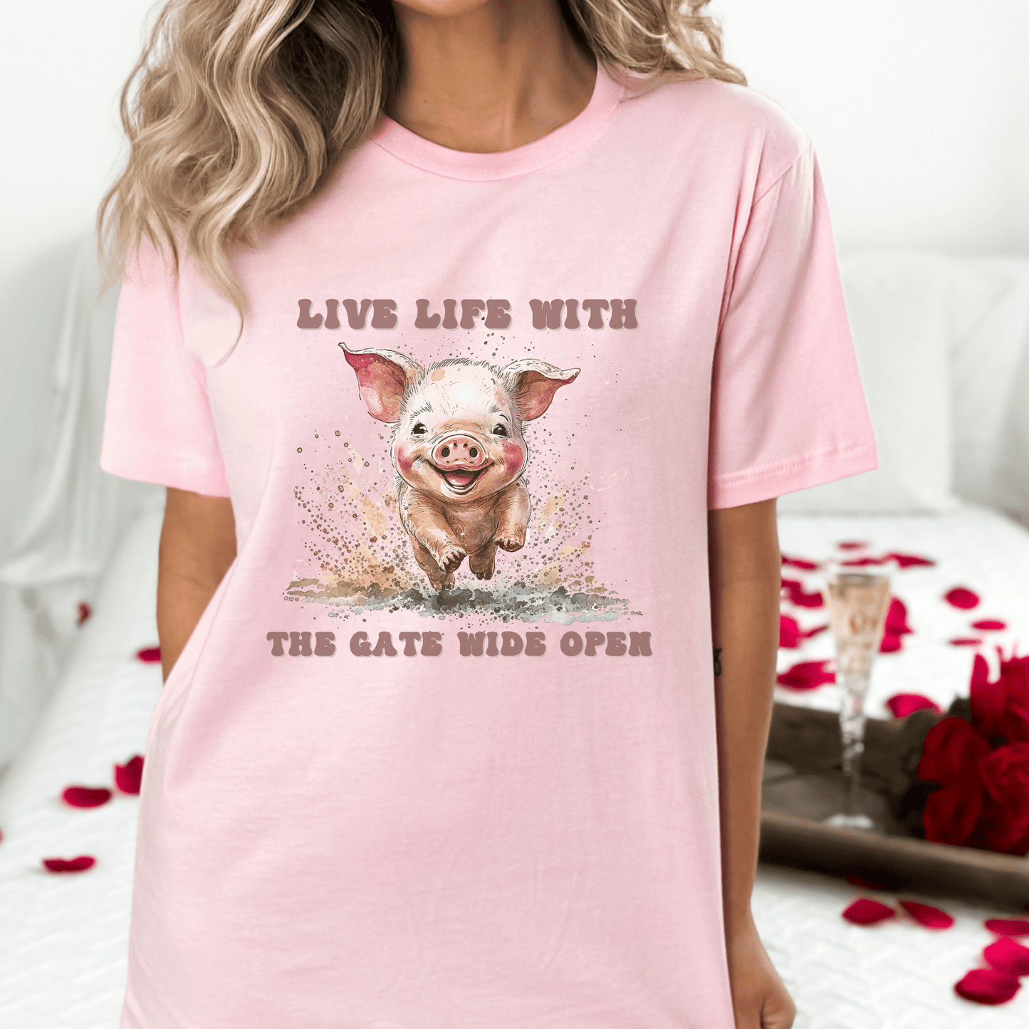 Introducing our Cute Piggy Tee, featuring a charming little pig happily running through the mud. With the inspirational message "Live life with the gate wide open," this farm animal-inspired t-shirt is perfect for anyone who loves country life. Made from high-quality materials, this pink pig shirt is both comfortable and stylish. Order now and show your love for adorable farm animals with our Piggy Shirt!