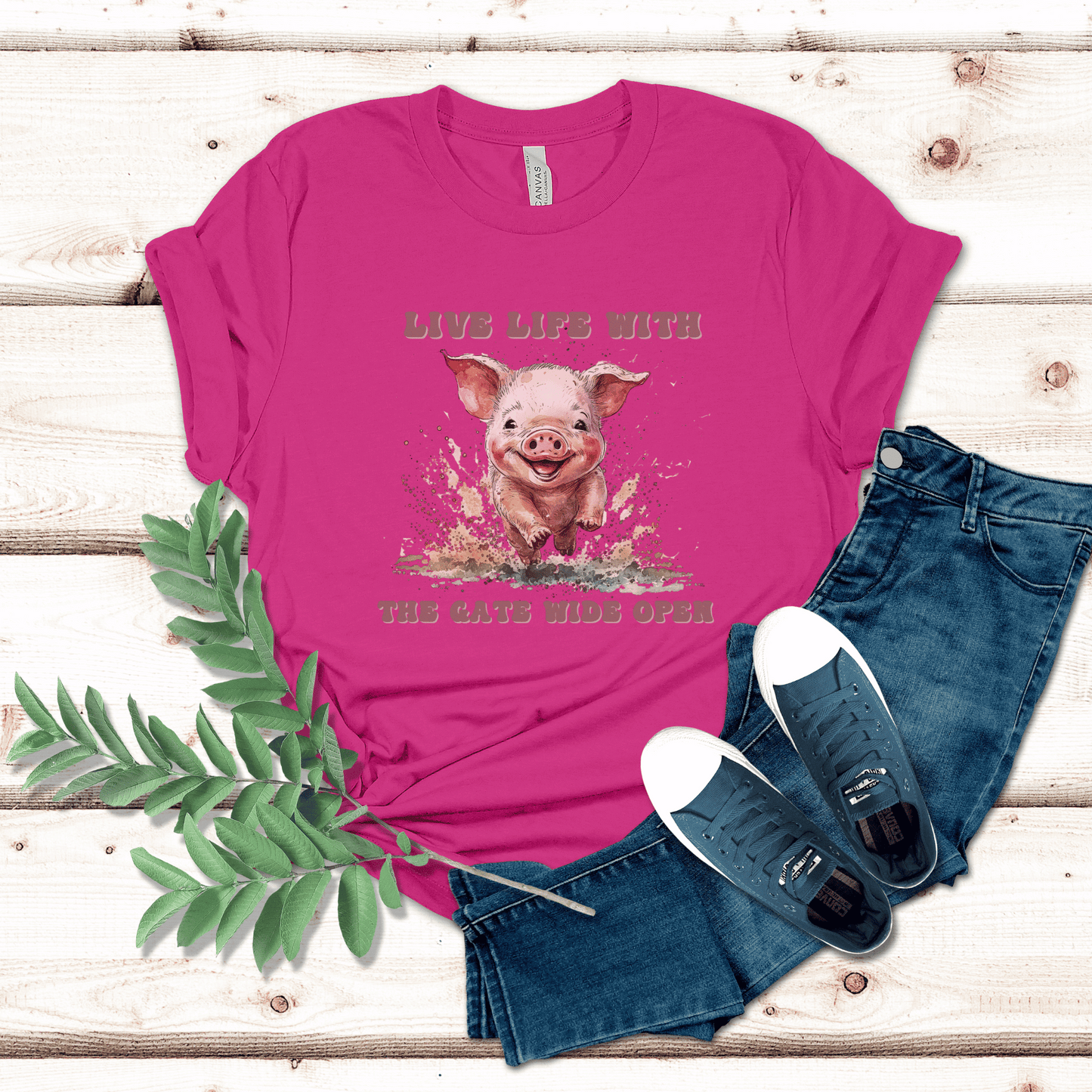 Introducing our Cute Piggy Tee, featuring a charming little pig happily running through the mud. With the inspirational message "Live life with the gate wide open," this farm animal-inspired t-shirt is perfect for anyone who loves country life. Made from high-quality materials, this pink pig shirt is both comfortable and stylish. Order now and show your love for adorable farm animals with our Piggy Shirt!