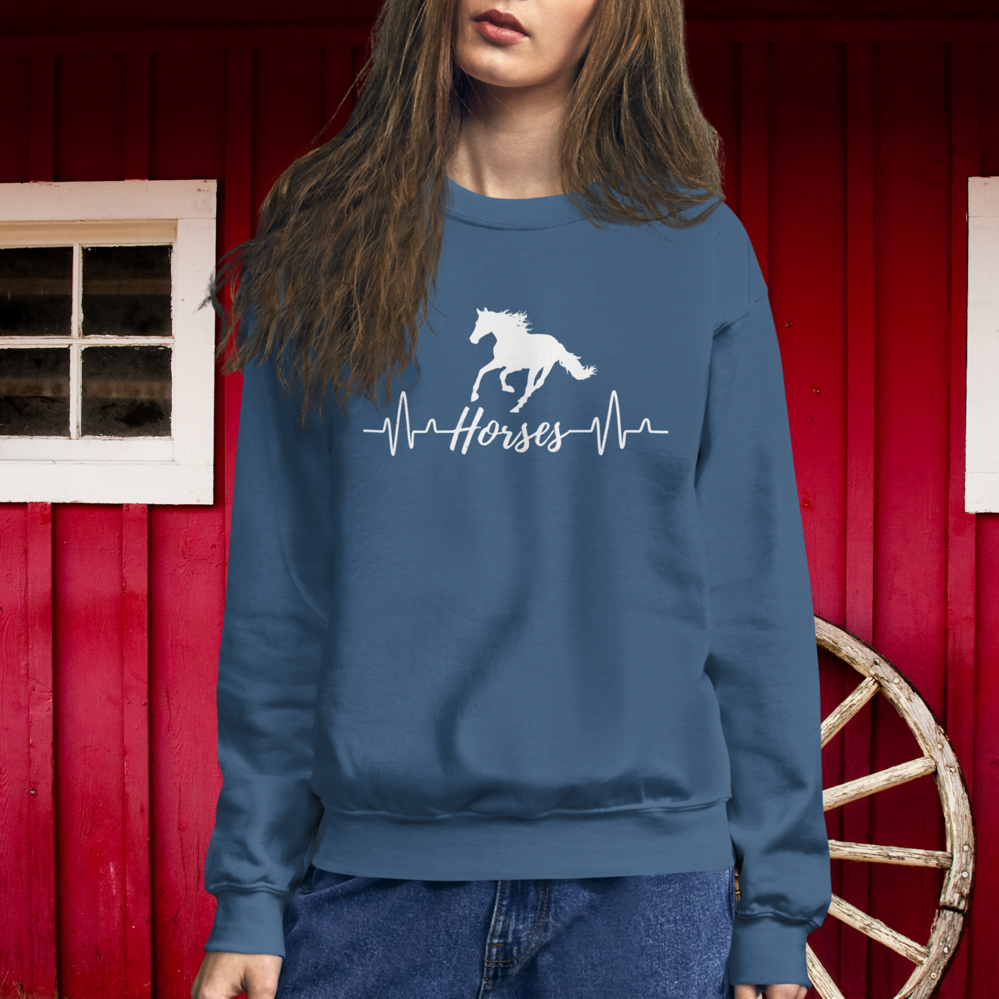 Silhouette of a horse with a heartbeat design with the word horses in the heartbeat .The design is all white printed on a Indigo sweatshirt.