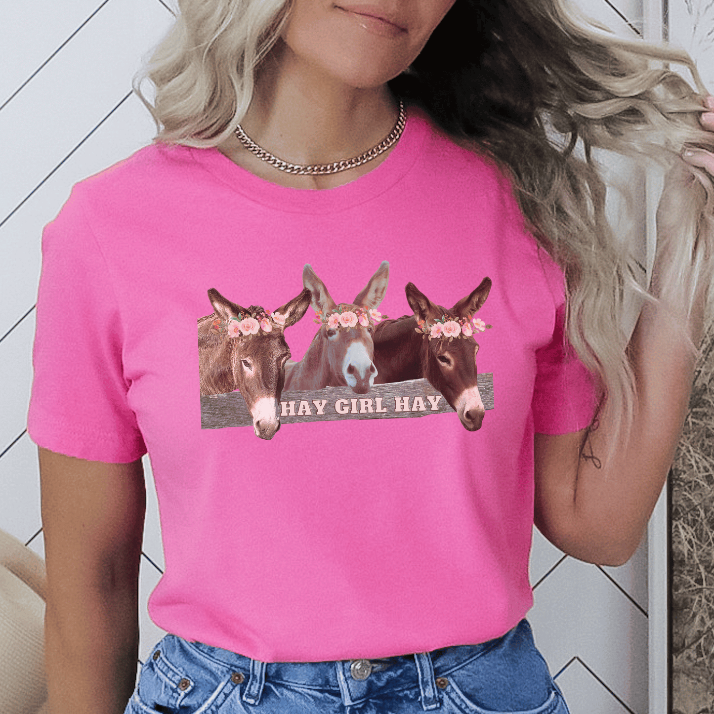 t-shirt featuring 3 adorable donkeys peering over a fence with the phrase "Hay Girl Hay". Perfect for donkey lovers, this high-quality tee is designed for everyday wear and is available in regular fit. Show off your love for donkeys with this cute and unique crew neck tee.