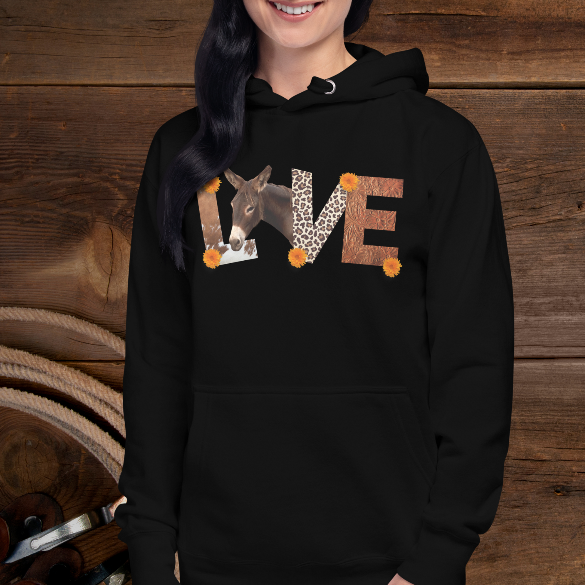 Black pull over hoodie sweatshirt with has the word Love spelled out with cow hide as the L , a donkey as the O, Leopard print and the V and tooled leather as the E