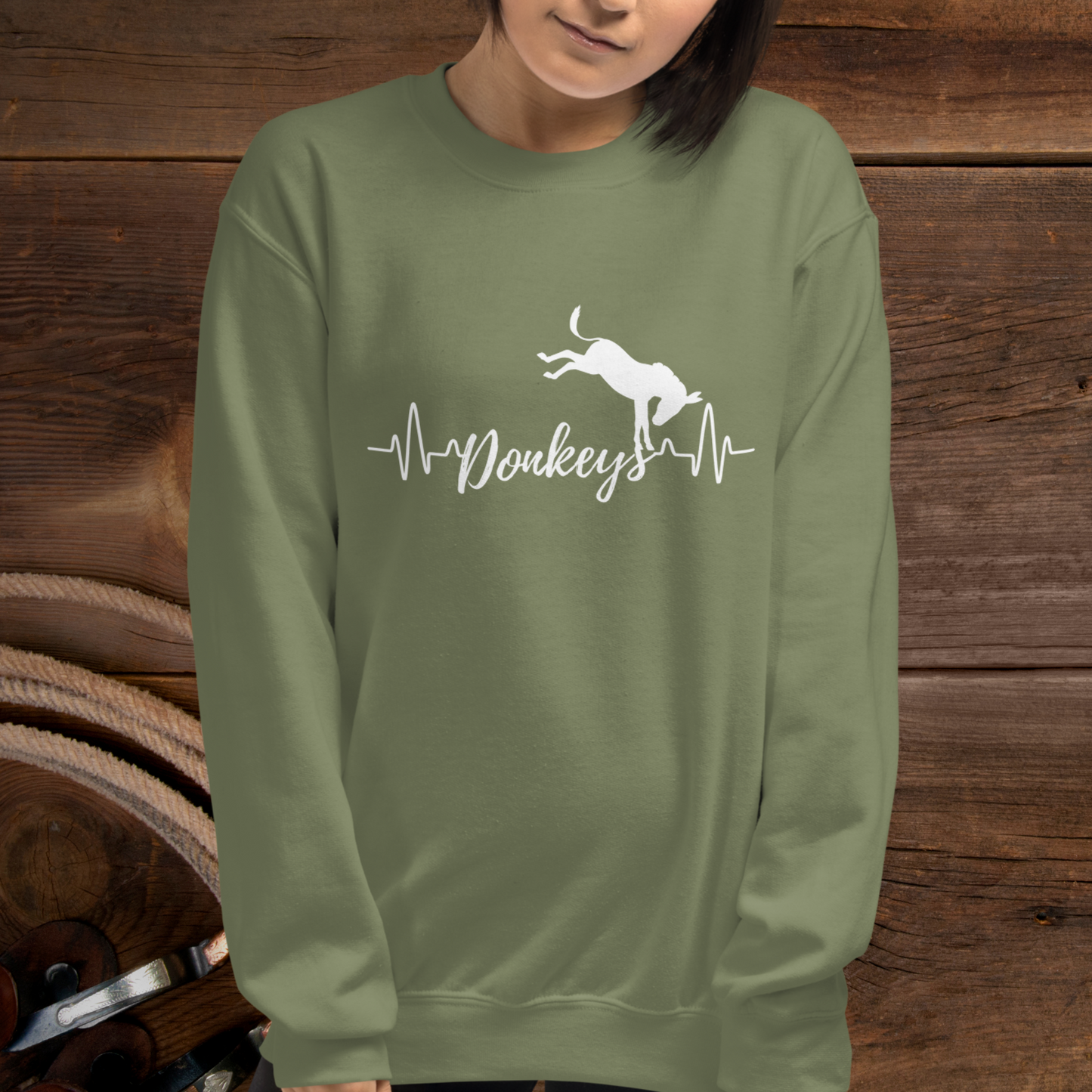 Military Green crew neck sweatshirt with a heart beat design with  the word Donkeys in the middle of the heartbeat, with a silhouette of a bucking donkey above it.