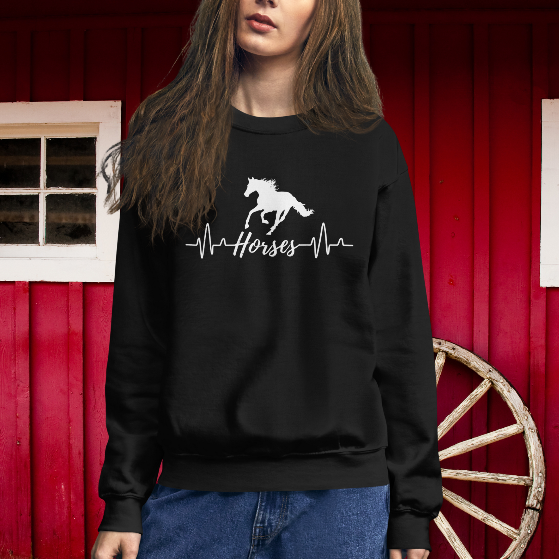 Silhouette of a horse with a heartbeat design with the word horses in the heartbeat .The design is all white printed on a black sweatshirt.