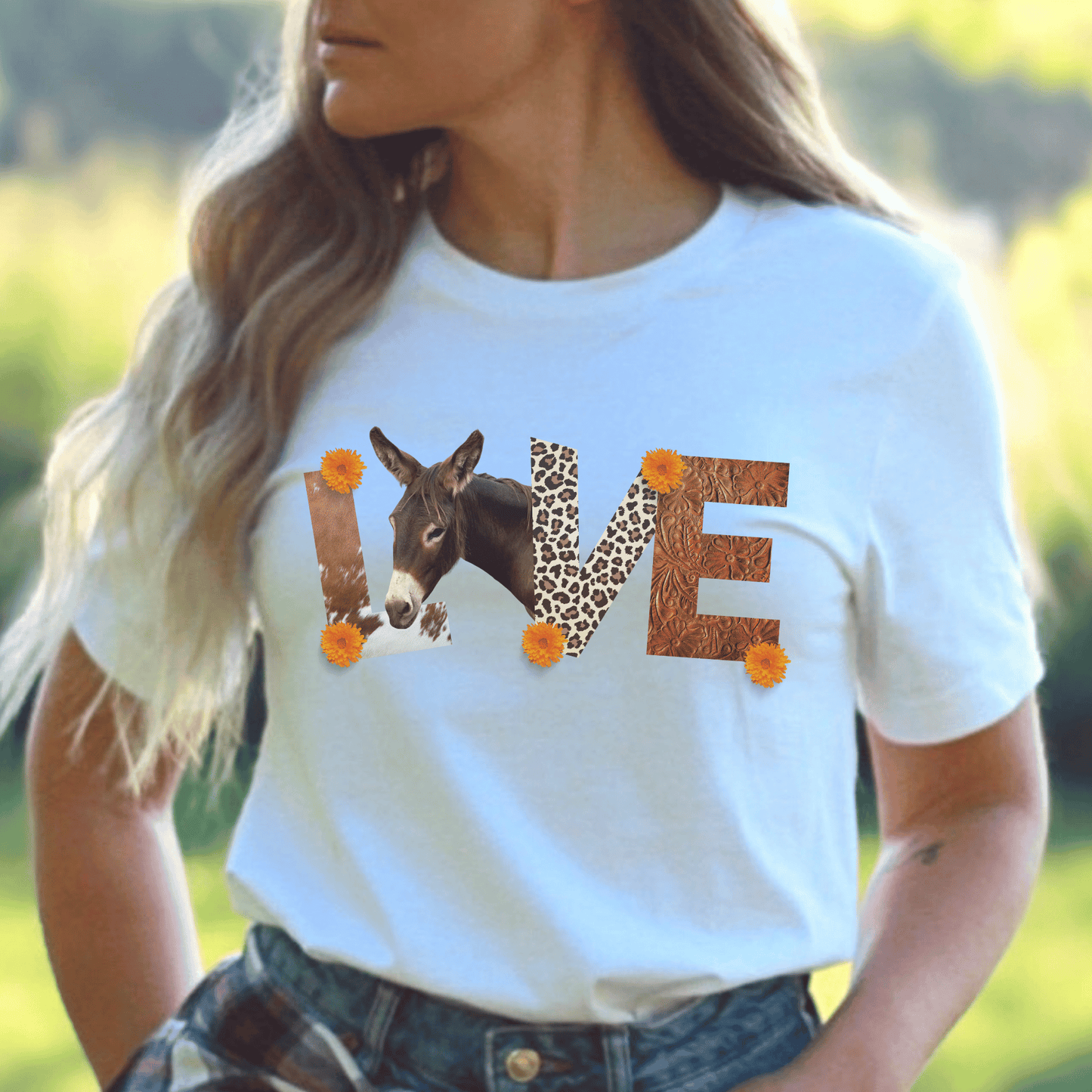 a white tee with leather letters  saying donkey love 